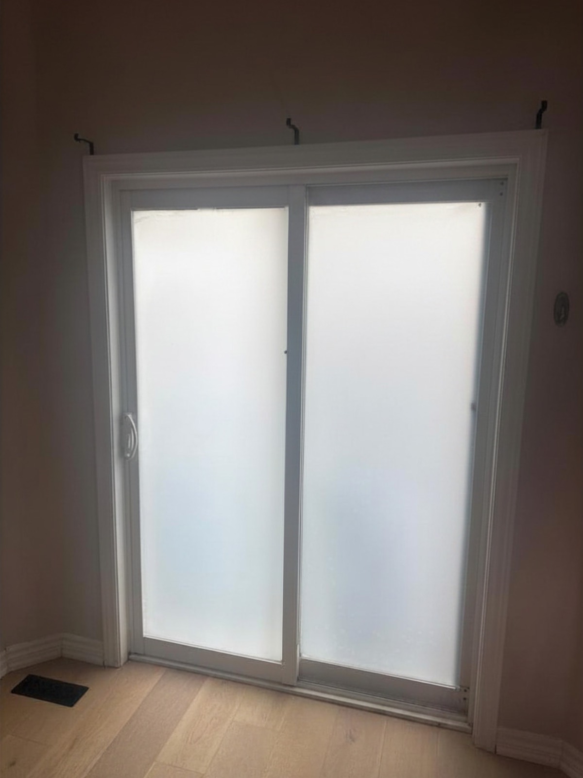 The same sliding glass door with the PDLC layer switched to its frosted private state