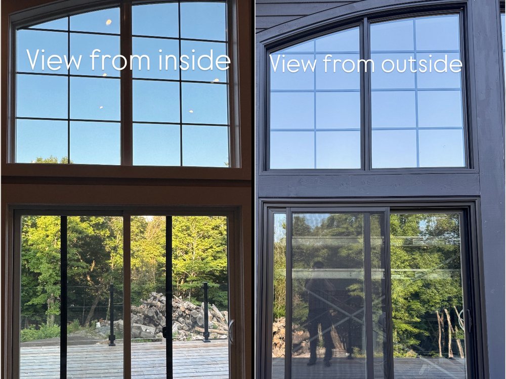 The same arched window and sliding door side by side: from inside, a clear view of the deck and trees; from outside, the glass shows a reflection instead of the room