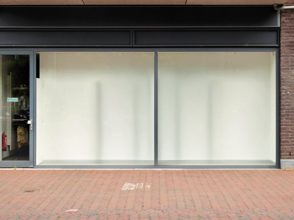 Ground-floor storefront glass protected with an invisible safety and security covering, clean and intact