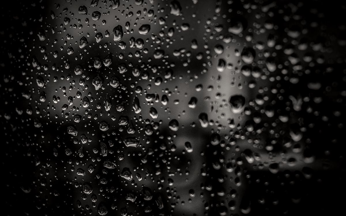 Close-up of water beading on glass treated with a hydrophobic surface protection coating